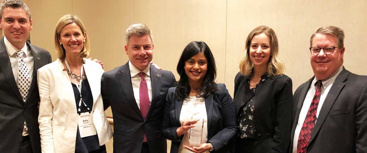 Uma Wilson posing with UMB's Leadership after receiving her most powerful women in banking award.