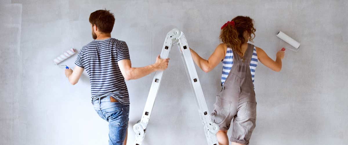 A couple that used a home equity line of credit are painting a room in their house.