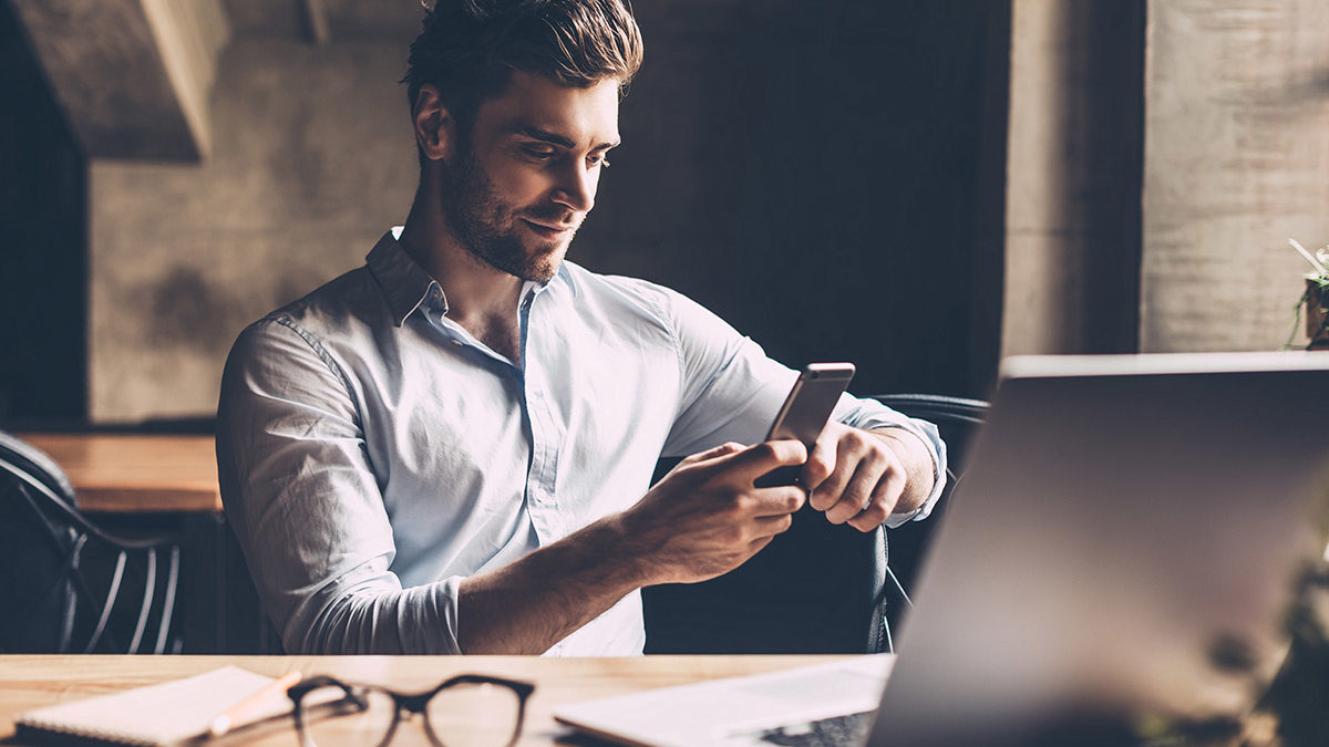 man managing debt at home desk